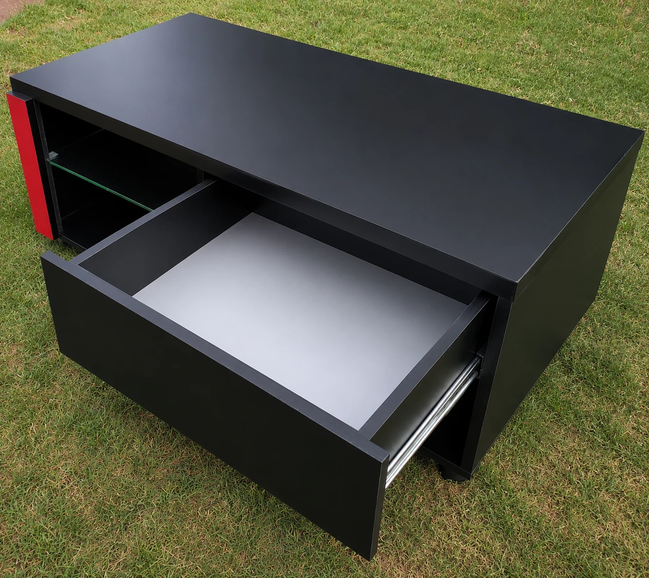Custom coffee table with open drawer and glass shelf
