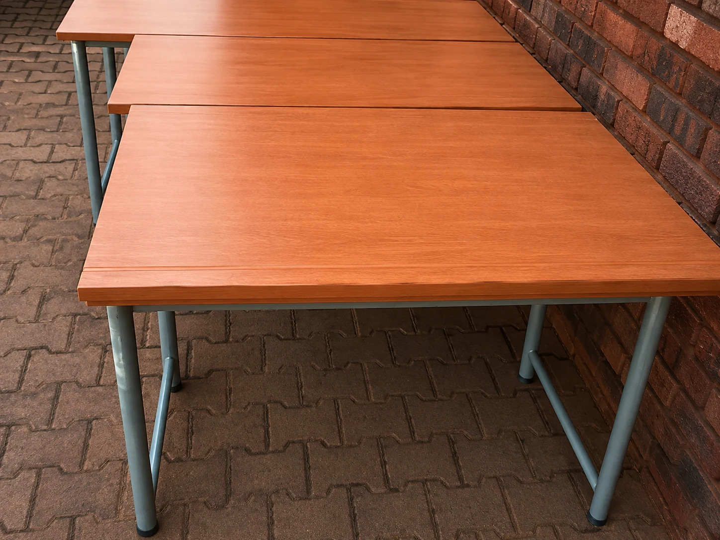 Close view showing the timber finish and steel frame of classroom desks